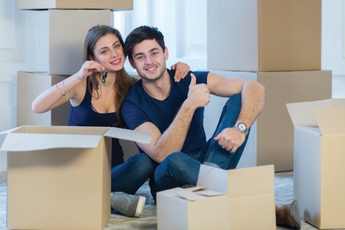 Furniture collection team handling a sofa in a Brent flat