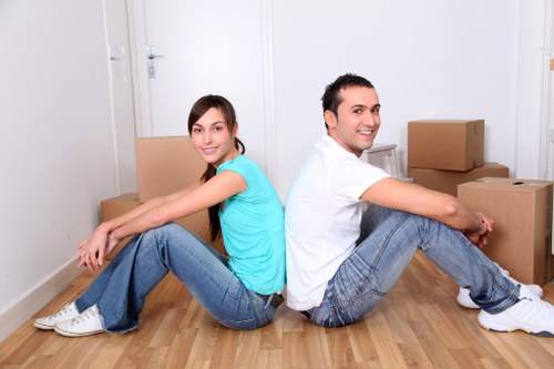 Local movers carrying furniture from a flat in Brent with stair access